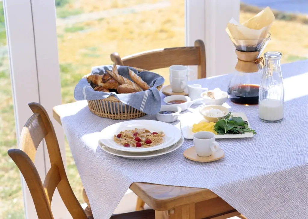 Table de petit-déjeuner dressée devant une fenêtre